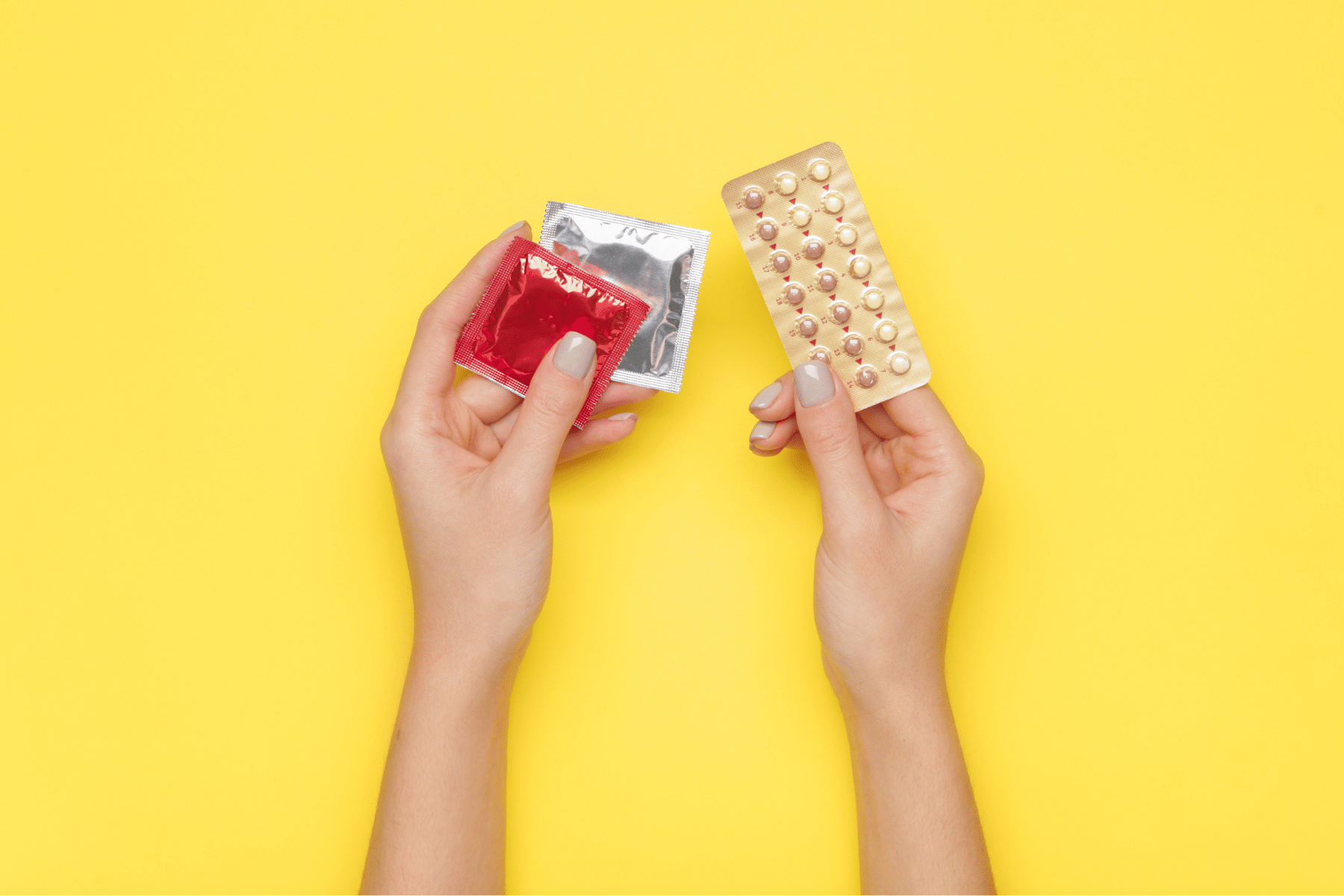 Close up of hands holding contraceptives