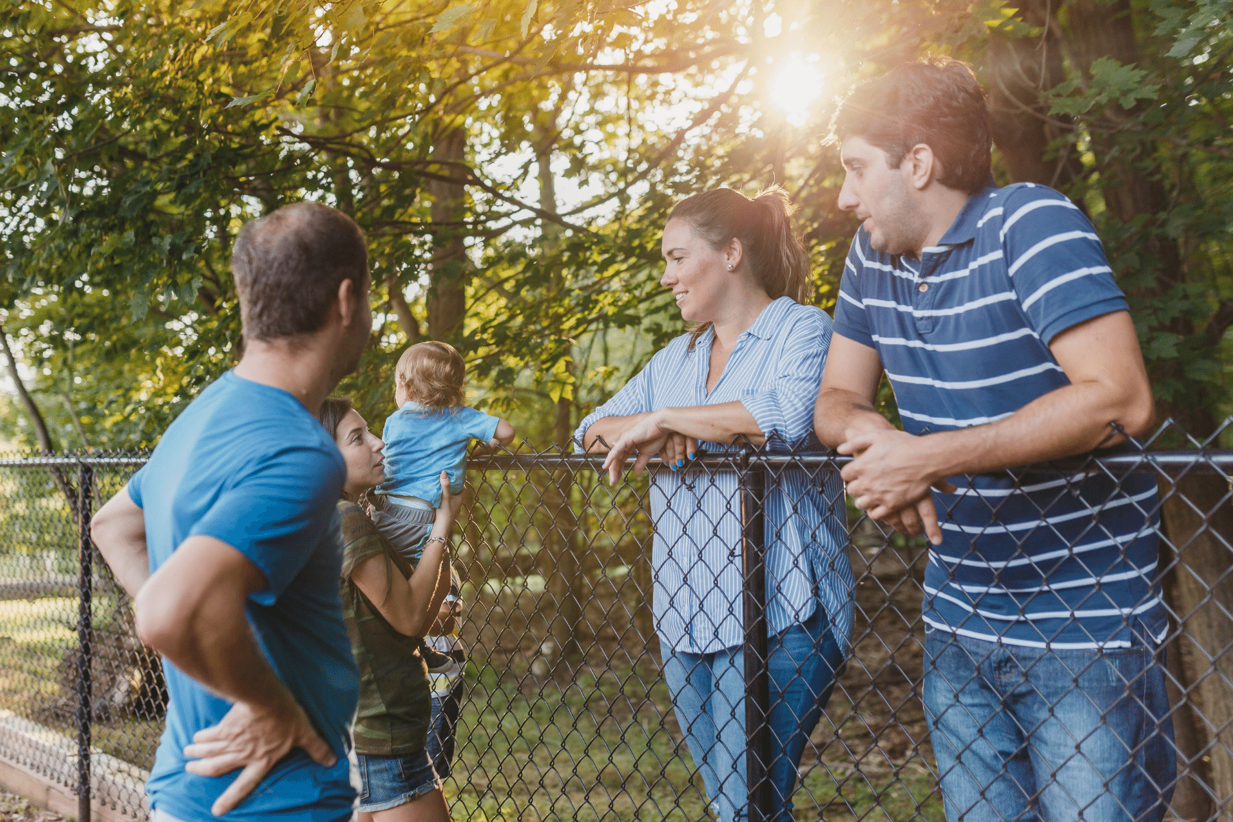 neighbors standing in a circle talking to one another