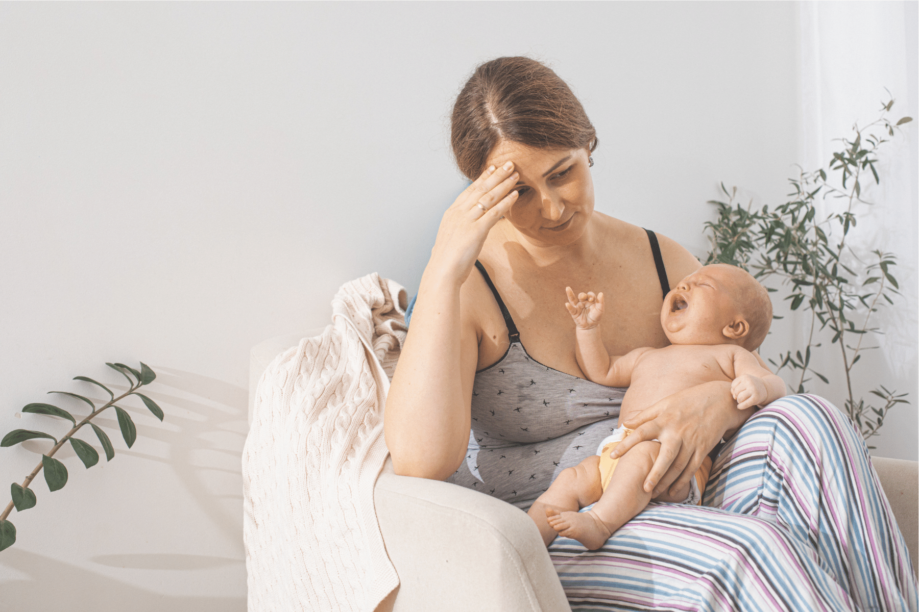 exhausted women holding a newborn baby