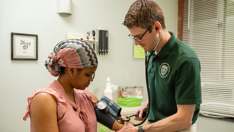 Picture of student in Hazen hall getting a blood pressure check.